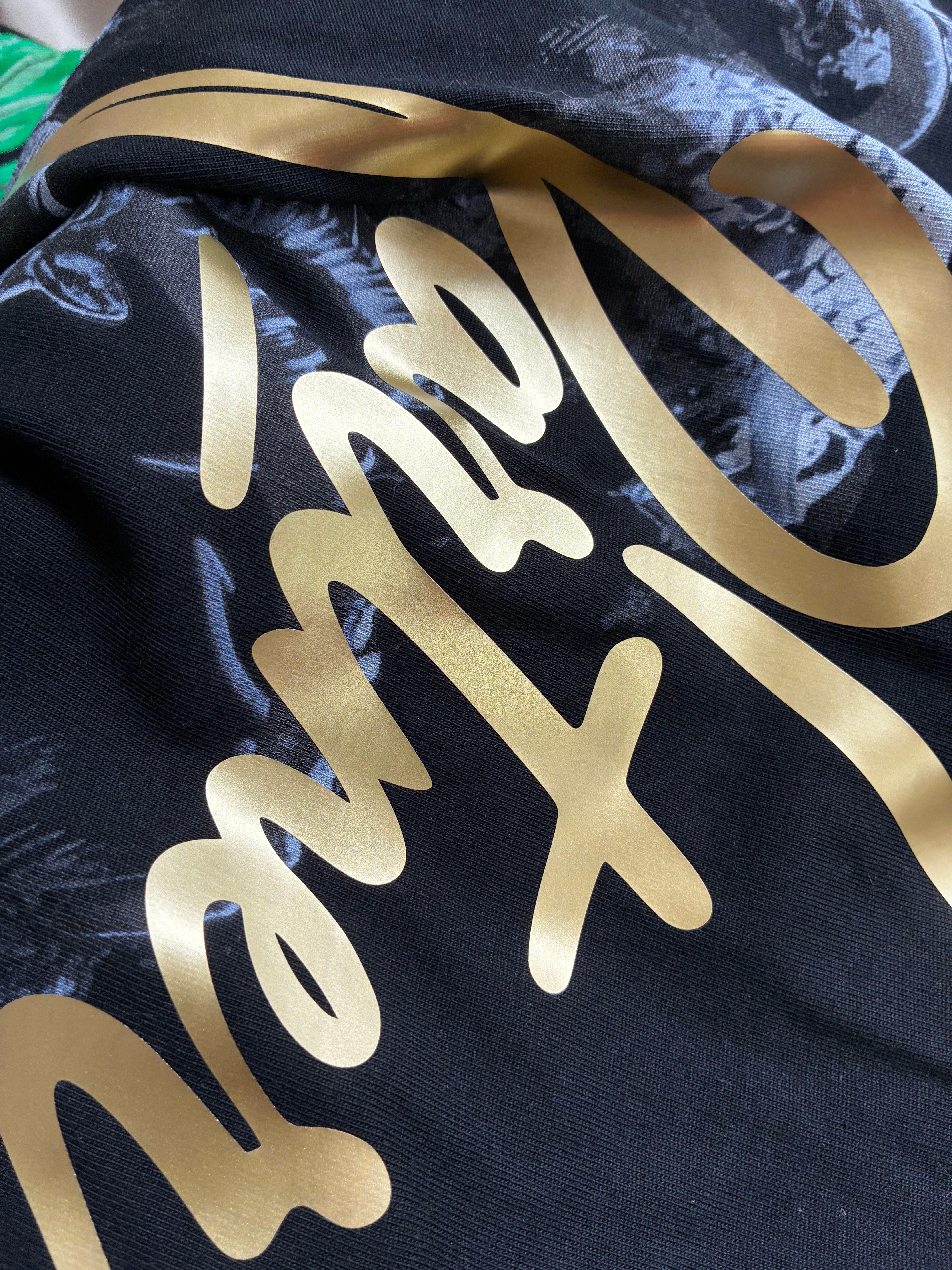 Metallic Heat Transfer Vinyl in gold — script lettering with a satin sheen on black fabric