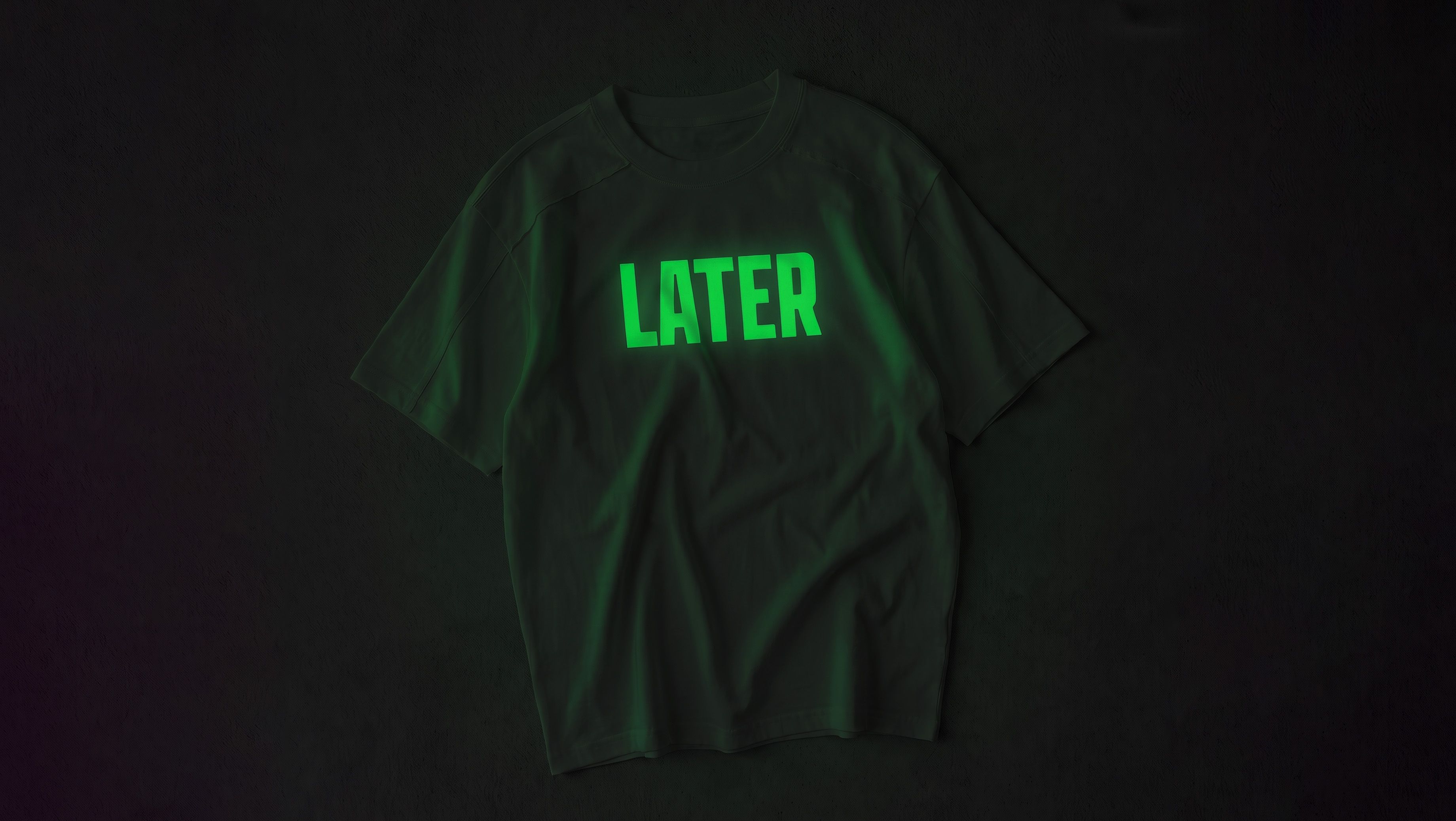 Glow Heat Transfer Vinyl in the dark — the LATER print charged and glowing green against black