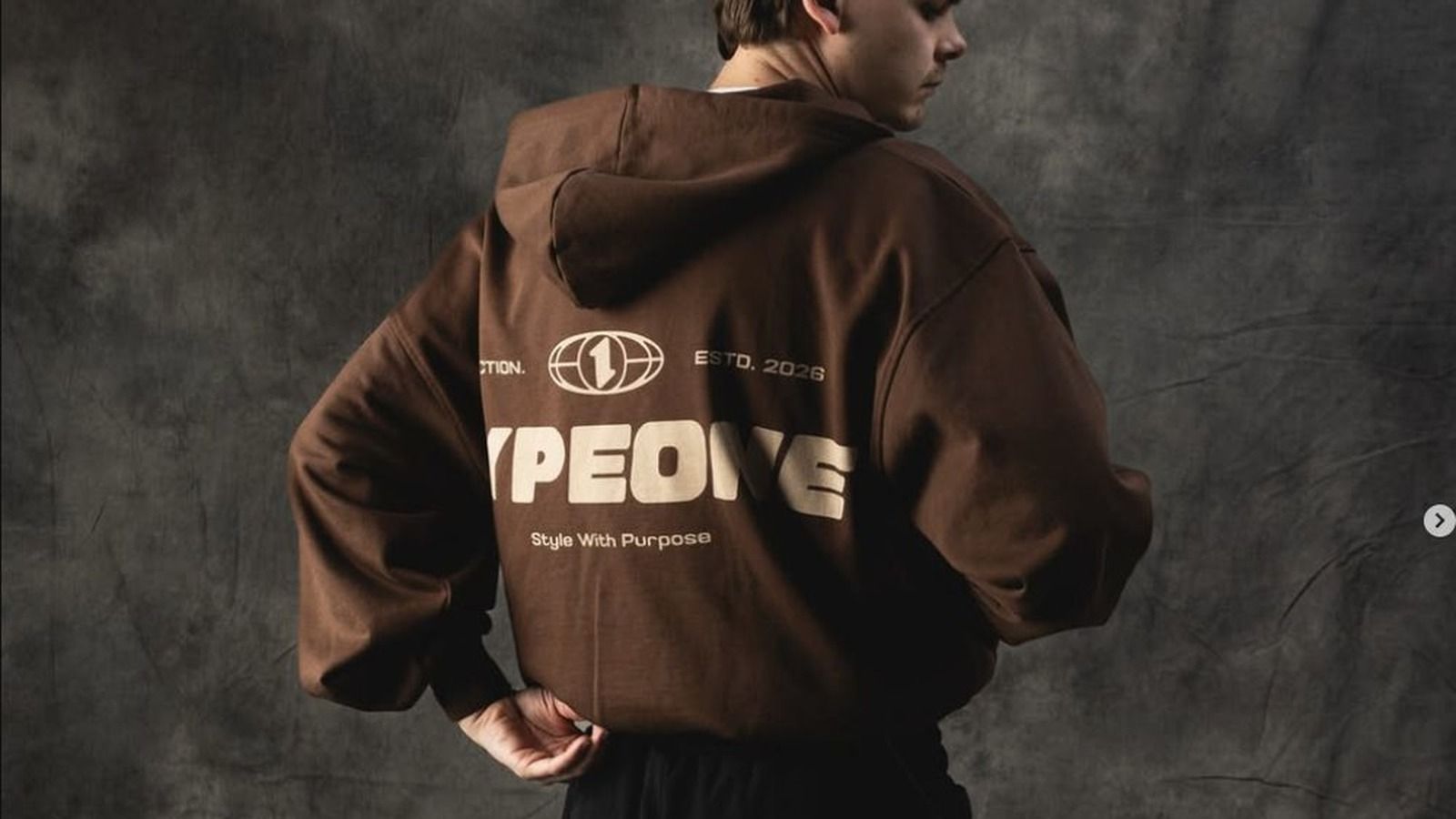 PODpartner retail brand hoodie: complete brand stack visualization with custom back graphic, demonstrating how 3-layer brand signals (packaging, hang tag, neck label) combine with decoration to create premium retail positioning beyond generic POD