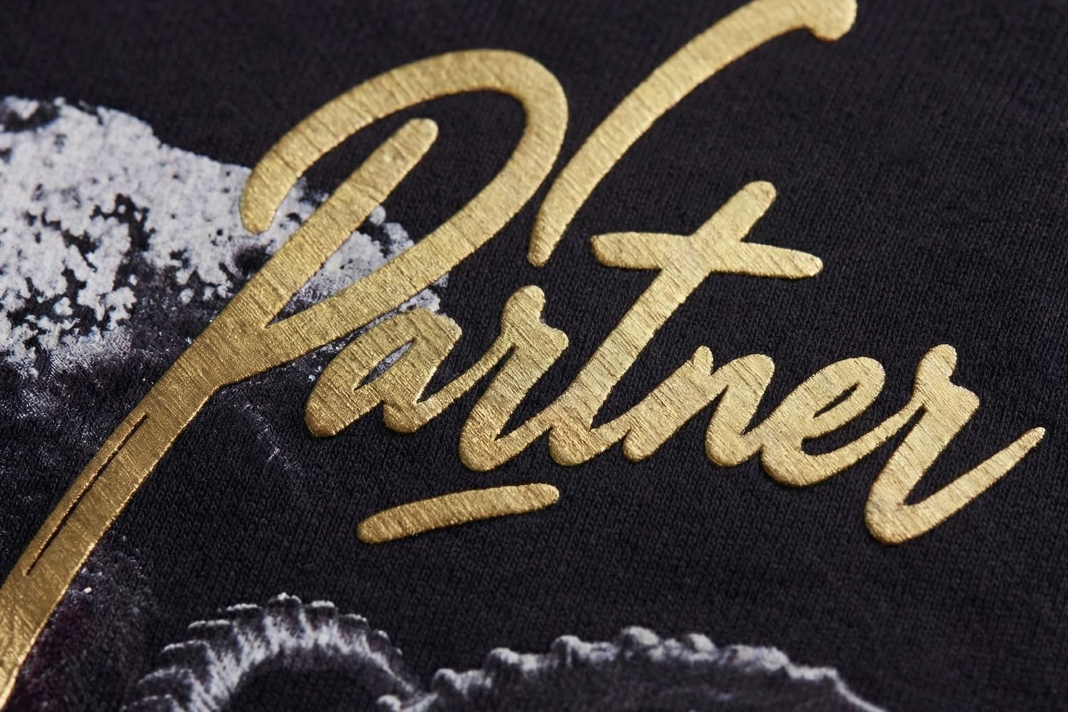 PODpartner Premium HTV close-up: 0.6mm raised Metallic gold finish on streetwear hoodie, demonstrating retail-quality dimensional touch comparable to luxury brand raised logos